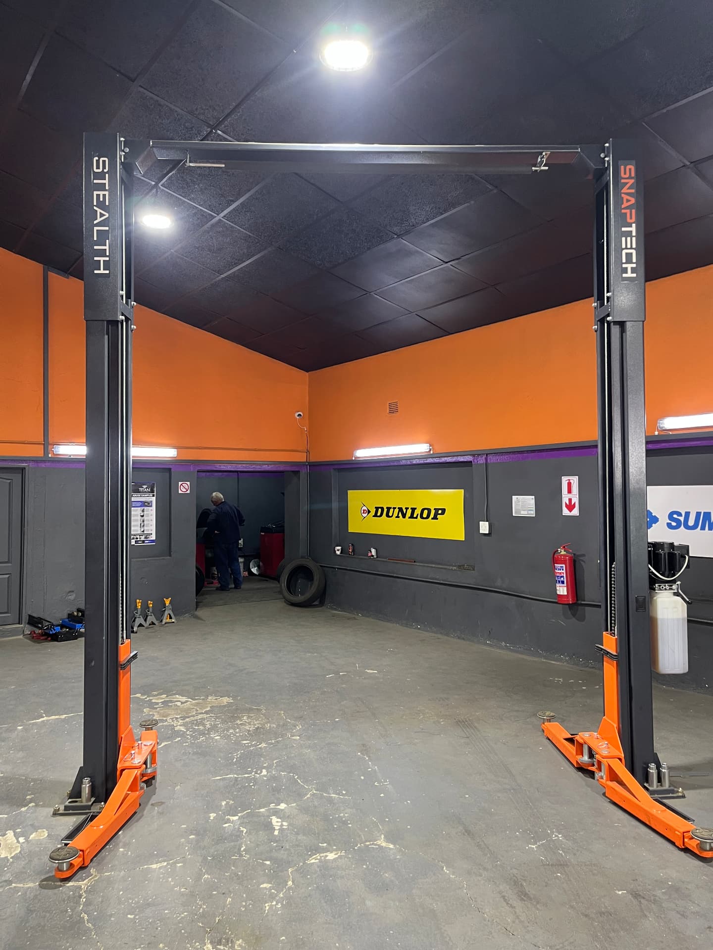 Stealth 2-post lift + brand wall